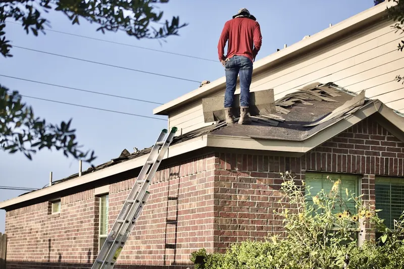 Professional roofer working on a residential roof in Damascus Manor